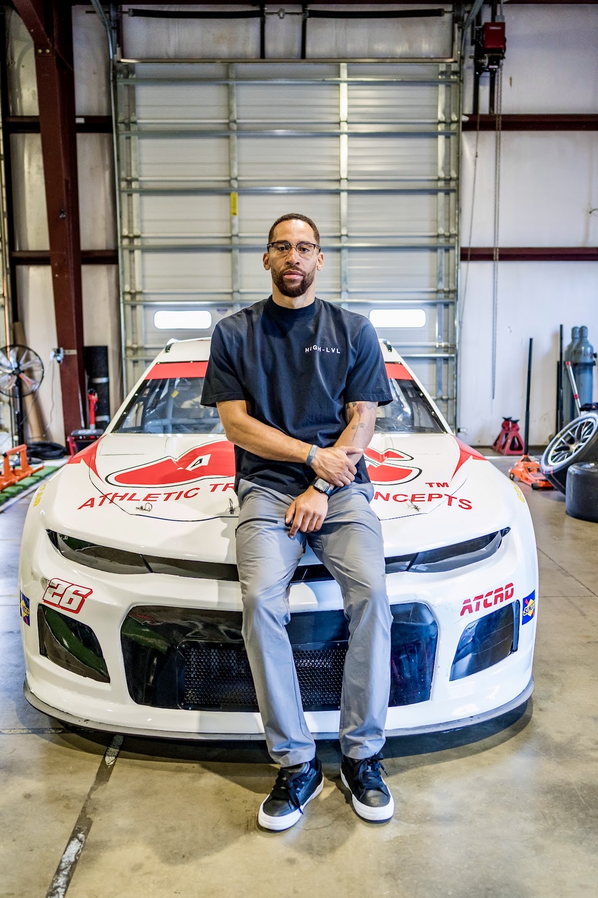 Jorden Paige seated on a NASCAR race car